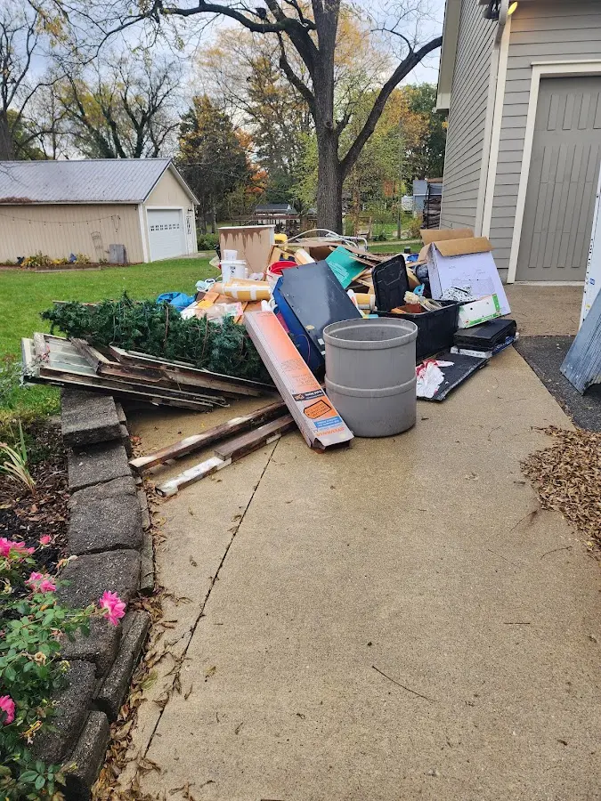 Dumpster being loaded with debris for Estate Cleanout Dumpster Rental in Gibson City